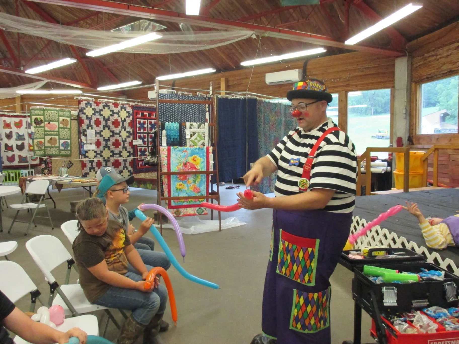 Teaching children to make balloon creations during an interactive balloon class
