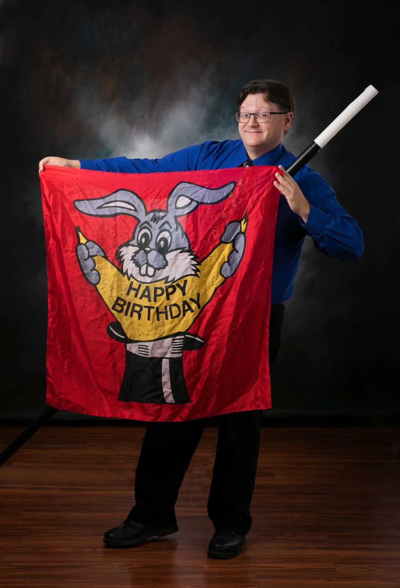Just 4 Laffs performer with a birthday-themed magic show banner