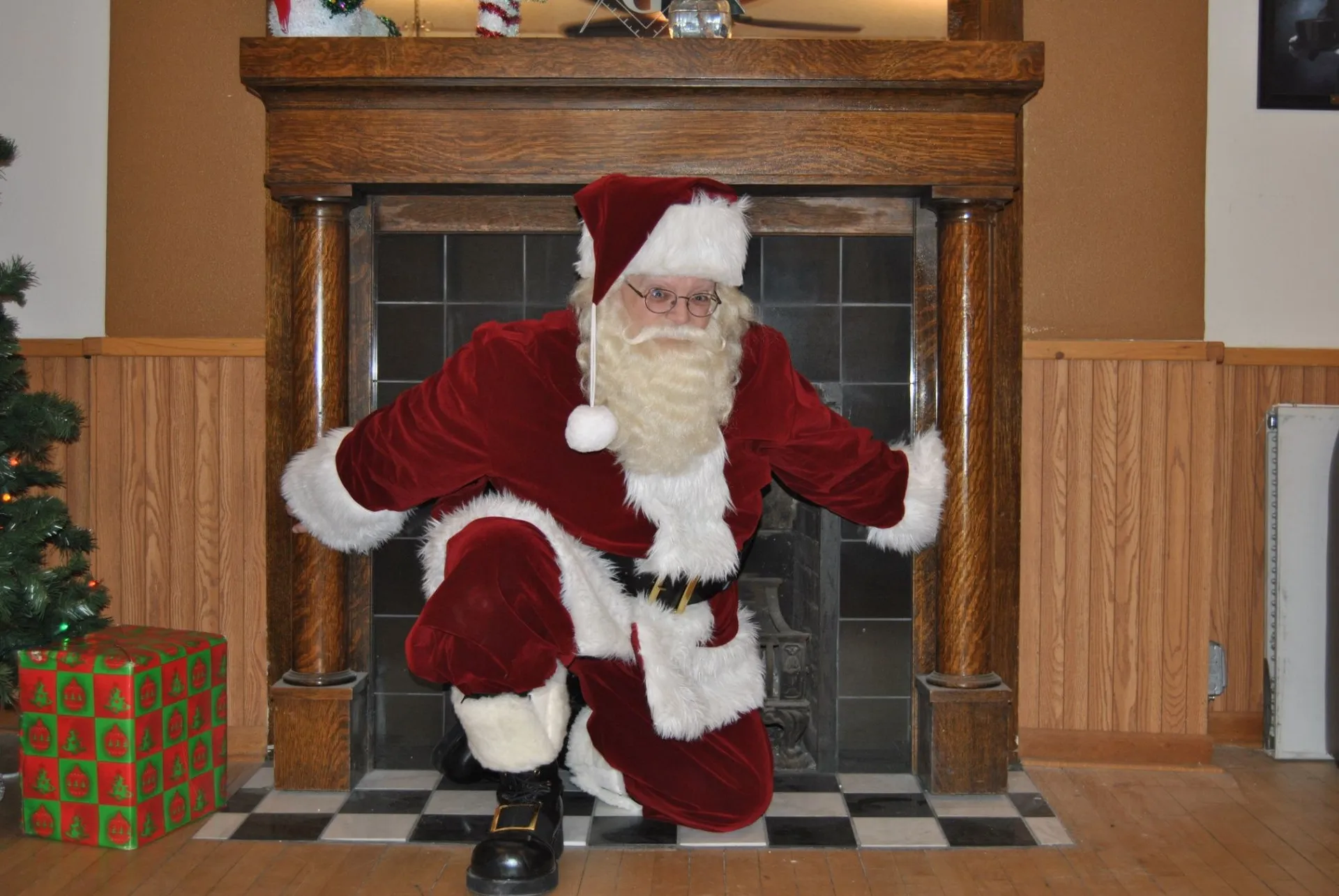 Santa character appearance by a fireplace
